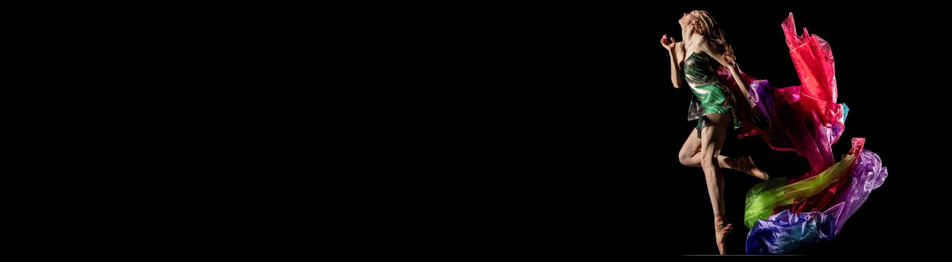 A member of Alonzo King LINES ballet against a black background