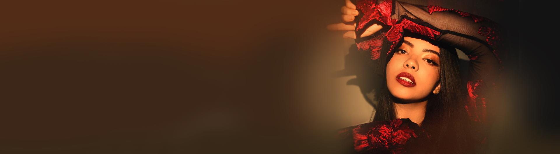 Lucía with her arm held up across her forehead.