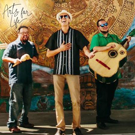 Three members of Jarabe Mexicano performing against a colorful backdrop.