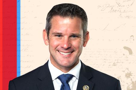 Adam Kinzinger in front of a document